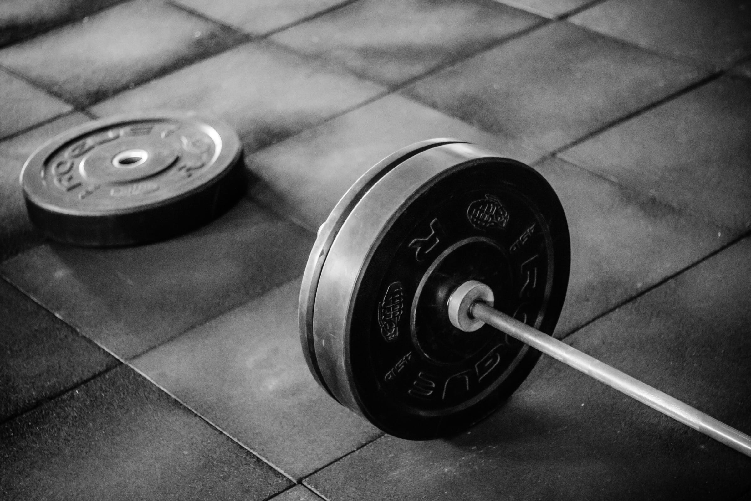 Ashe Morgan setting up a barbell in the studio